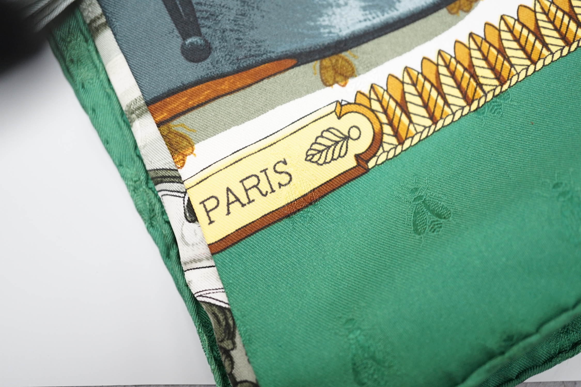 Four vintage Hermes silk scarves including two retailed by Harrods comprising Cuivreries, Roues de Canon, Napoleon and Puzzle
